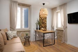 a living room with a table and a couch at Apartment City Walls in Old Town of Rovinj in Rovinj