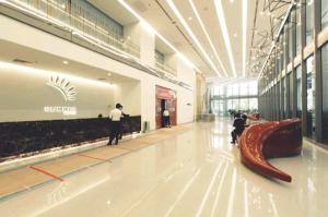 a man standing in a shopping mall with a shoe on the floor at Mercu Summer Suites KLCC by Star Residence in Kuala Lumpur +42 photos