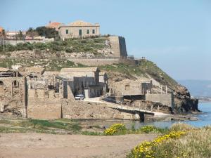 a castle on top of a hill next to the water at Casa Vacanze Antares in Portopalo