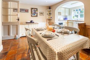 a kitchen and dining room with a table and chairs at Bluebell Cottage - Norfolk Cottage Agency in Burnham Market +21 photos