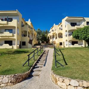 a walkway in front of two apartment buildings at Casa Dourada in Alvor