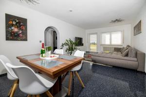 a living room with a table and chairs and a couch at Ferienwohnung Melissa in Villingen-Schwenningen +7 photos