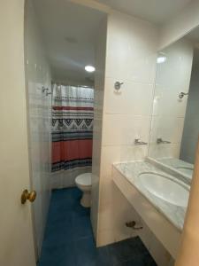 a bathroom with a sink and a toilet at Intimo Hotel Miraflores in Santiago +44 photos