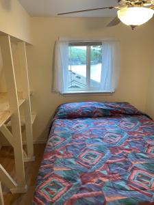 a bed in a room with a window at Loft , boat dock, 2 bedrooms , pet friendly in Gravois Mills
