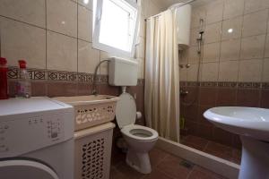 a small bathroom with a toilet and a sink at Eco Village experience - Skadar Lake in Virpazar +4 photos