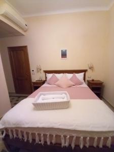 a bed with a white tray on top of it at BnB Villa Melany vicino Centro in Lucca