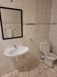a bathroom with a sink and a toilet and a mirror at Jacmo Guest Private Rooms in Cape Town +8 photos