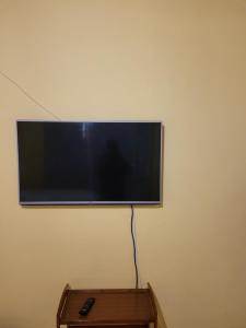 a flat screen tv hanging on a wall at Jacmo Guest Private Rooms in Cape Town