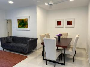 comedor con sofá, mesa y sillas en Fairway 2 Bedroom Luxury Apartment with Gym and Pool en Battaramulla
