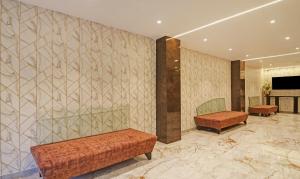 a waiting room with two benches and a wall at Treebo Tryst Seven Lake View in Hyderabad