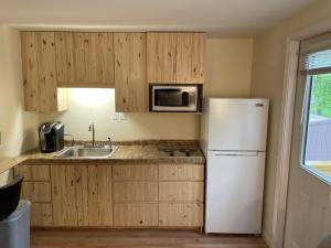 a kitchen with a white refrigerator and a sink at Loft , boat dock, 2 bedrooms , pet friendly in Gravois Mills