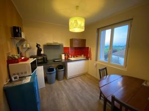 a small kitchen with a table and a dining room at studio type 1bis avec une 20 de marche a monte in Gourdon