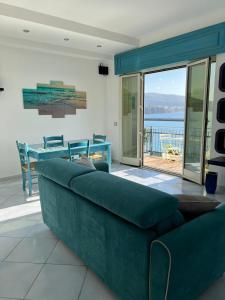 a living room with a couch and a view of the water at Residenza Mare di Sotto Sorrento in Meta