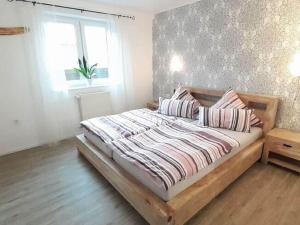 a large bed in a bedroom with a window at Quiet apartment along a stream in Halenfeld in Sellerich