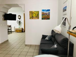 a living room with a couch and two paintings on the wall at Alojamiento rural Los Pérez Lucainena de las Torres in Lucainena de las Torres