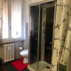 a bathroom with a shower and a toilet at Apartment Ponte delle Nazioni in Parma