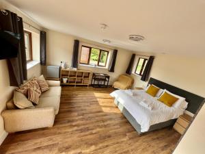 a bedroom with a bed and a couch at Lillypool Farm in Shipham