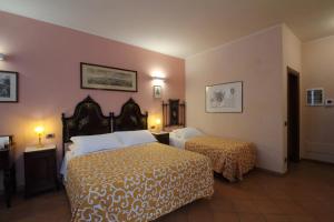 Säng eller sängar i ett rum på Palazzo Rustici b&b & apartments