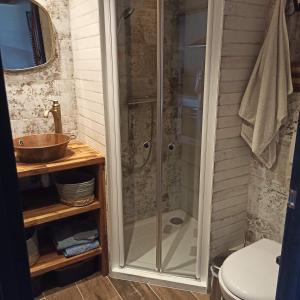 a shower with a glass door in a bathroom at Ty Calouenn, la plage à pied in Le Pouldu