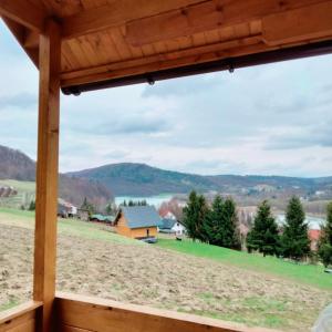 a view from the porch of a cabin with a view of the mountains at Pod Bercem in Solina