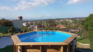 a swimming pool on top of a house at VILLA BLANCA 10 minutos de la Playa Costa brava in Maçanet de la Selva