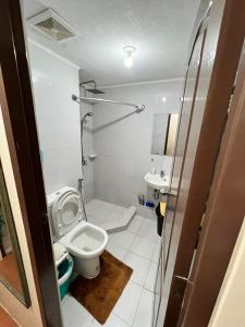 a small bathroom with a toilet and a sink at One Oasis by Paseo de Corazon Residence in Cagayan de Oro