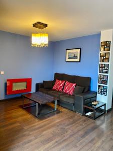 a living room with a couch and a table at Atico Deluxe San Basilio in Córdoba