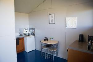 a small kitchen with a small table and chairs at Tone valley view glamping in Wellington