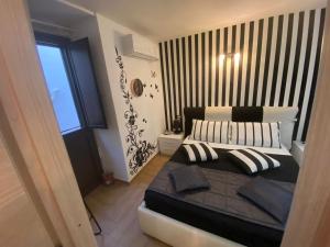 A bed or beds in a room at Residence Emozioni Ortigia
