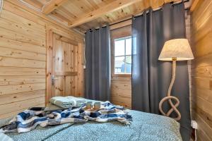 a bedroom with a bed in a wooden cabin at Wood Village in Winiec