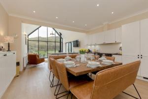 a kitchen and dining room with a table and chairs at Balbeg Cottage in Straiton