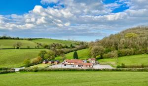 an aerial view of a house in a green field at Lillypool Lodges in Cheddar