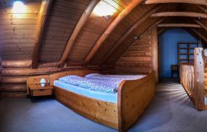 a bedroom with a bed in a log cabin at Domek na Skałce in Żabnica