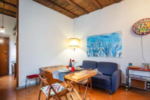 ローマにあるSANTA MARIA MAGGIORE Apartmentのリビングルーム(テーブル、青いソファ付)