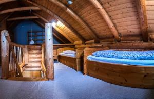 a room with two beds in a log cabin at Domek na Skałce in Żabnica