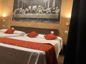 two beds in a room with a painting on the wall at Albergo Corvetto Corso Lodi in Milan