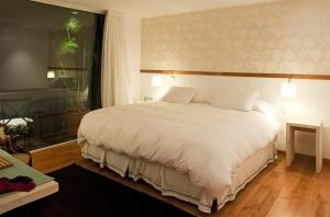 Postel nebo postele na pokoji v ubytování Hotel Casa Zapallar