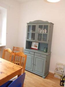 a blue cabinet in a dining room with a table at Haus Pfaffenfels in Schönau