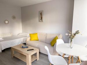 a living room with a couch and a table at El Horriu in Llanes