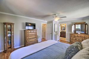 a bedroom with a bed and a dresser at Lake House Haven Fire Pit, Boat Dock and More! in Watauga