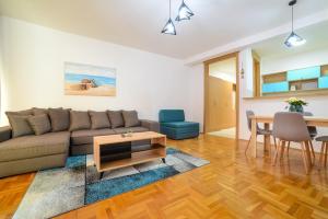 a living room with a couch and a table at Apartment Hanja in Bar