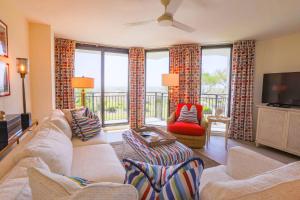 a living room with a couch and chairs and a television at Array of Sunshine Condo in Isle of Palms