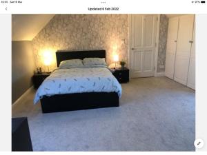 a bedroom with a large bed with two night stands at Cois na Mara Eire code V15 T677 in Bridge of Ross