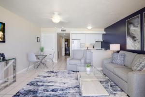 a living room with a couch and a table at Beachfront condo with restaurant, pool, spa and gym in Marco Island