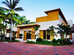 a building with palm trees in front of it at Fiesta Americana Puerto Vallarta All Inclusive & Spa in Puerto Vallarta