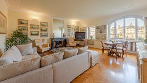 a living room with a couch and a fireplace at Ponte Vecchio 3 bedroom apartment in Florence