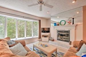 a living room with a couch and a fireplace at Condo on Lake Keowee with Resort Amenities and Pool! in Salem