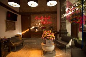 a lobby with a fireplace with a sign that reads rental agency crime at Casa Pepe in Puebla