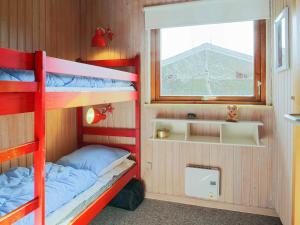 a bunk bed room with two bunk beds and a window at Holiday home Dannemare XXX in Dannemare