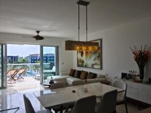a living room with a couch and a table at Mareazul Luxury ocean view penthouse and private beach club in Playa del Carmen